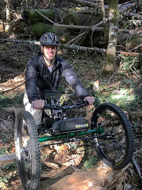 特雷弗·丹宁骑着越野轮椅在森林里